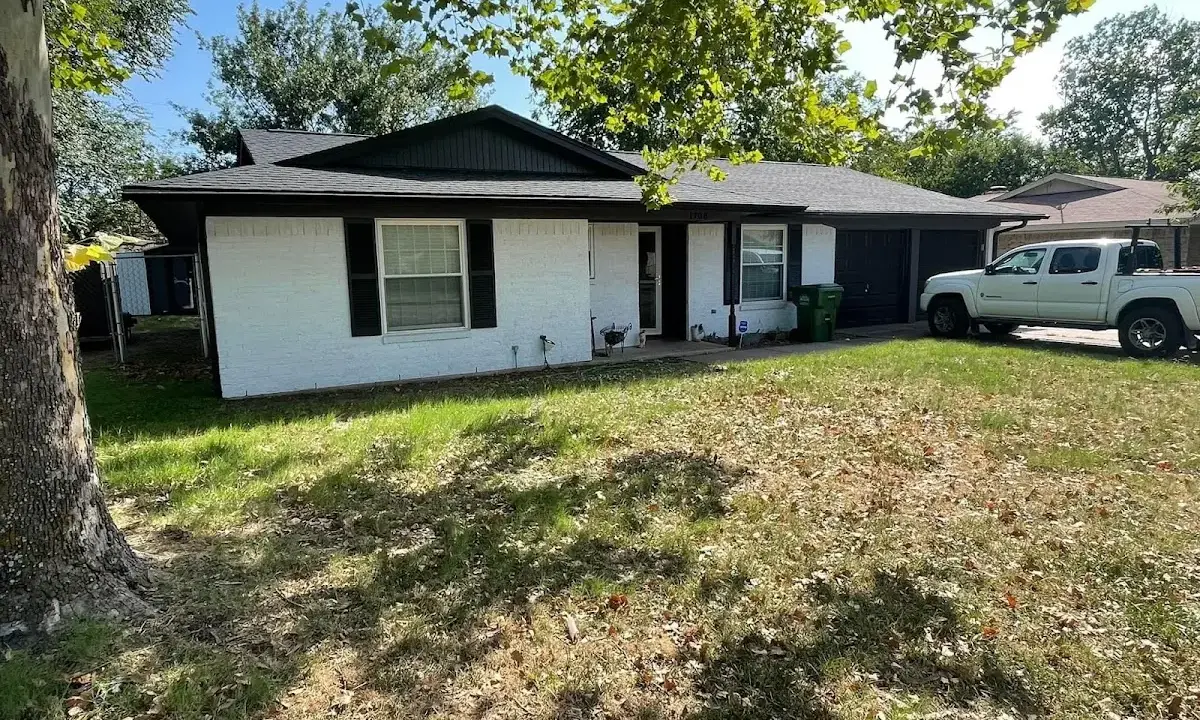Professional roofing crew working on a residential roof in Scottsboro